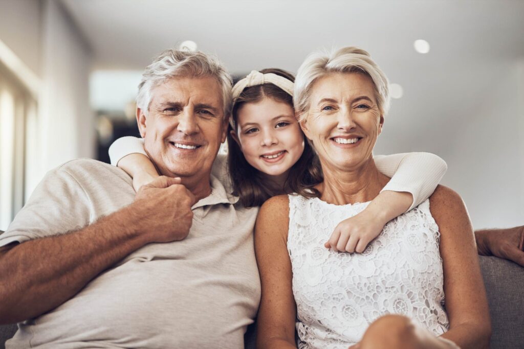 A happy couple and their child smiling and hugging