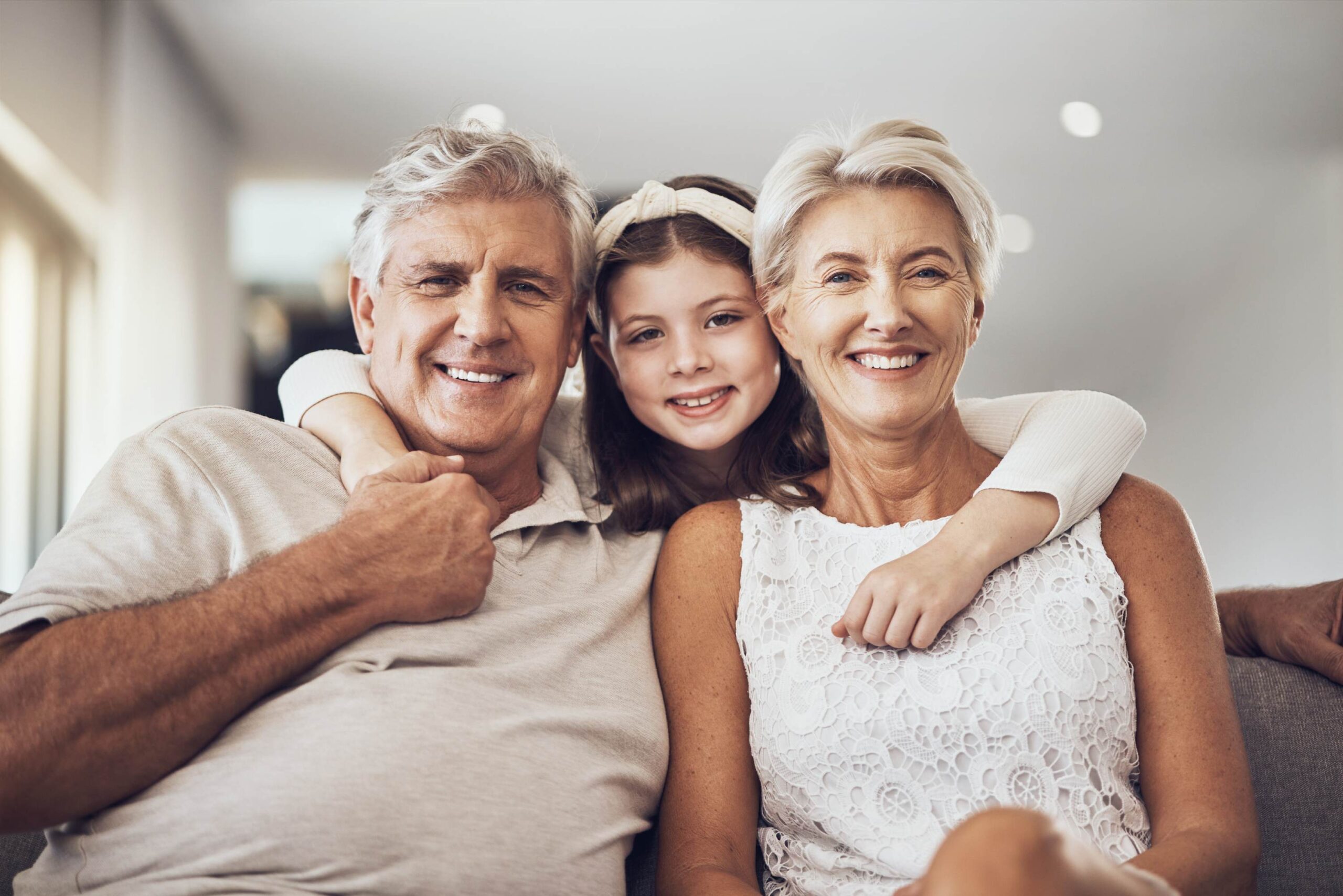 A happy couple and their child smiling and hugging